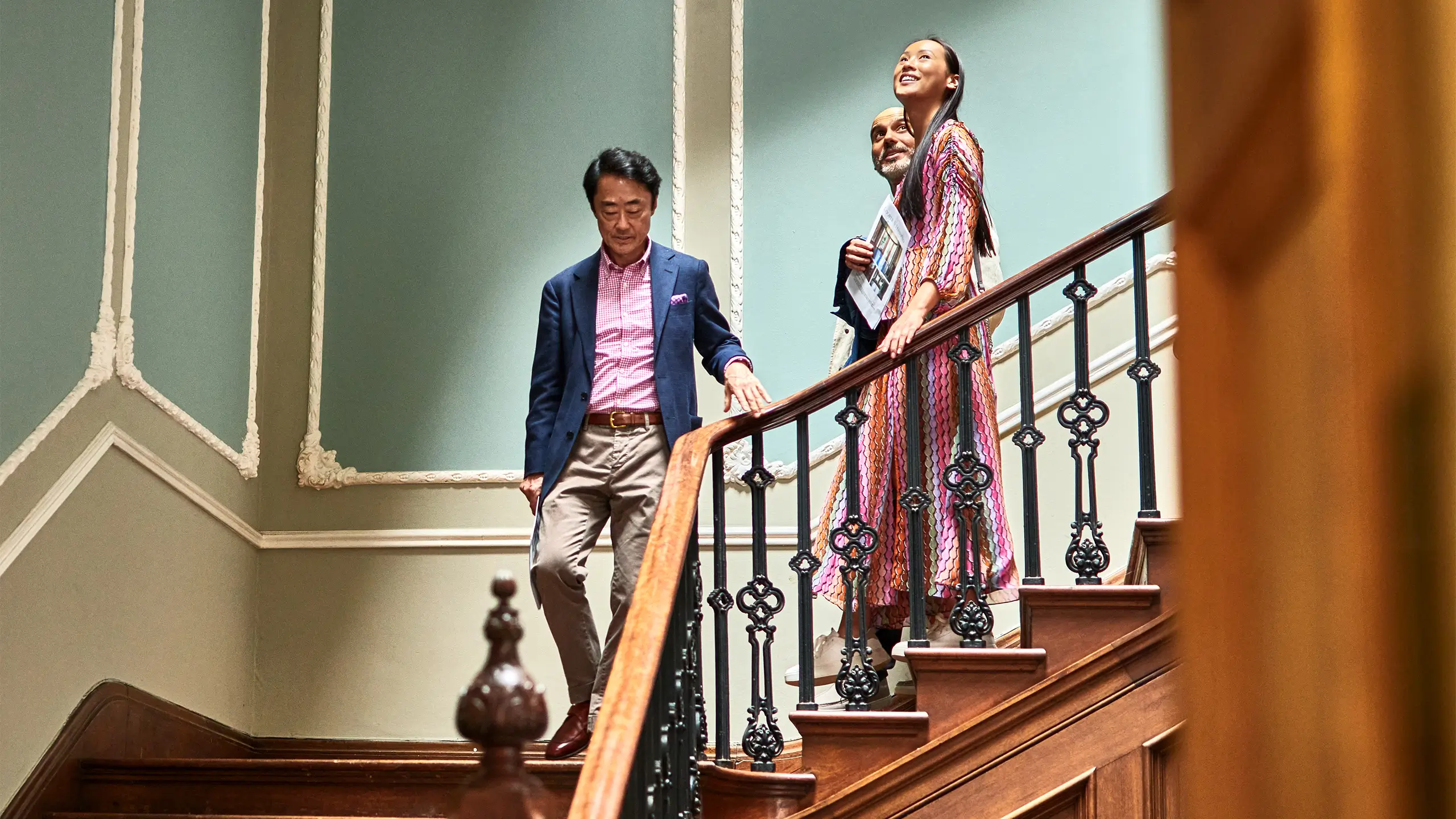 Estate agent showing wealthy couple spacious house