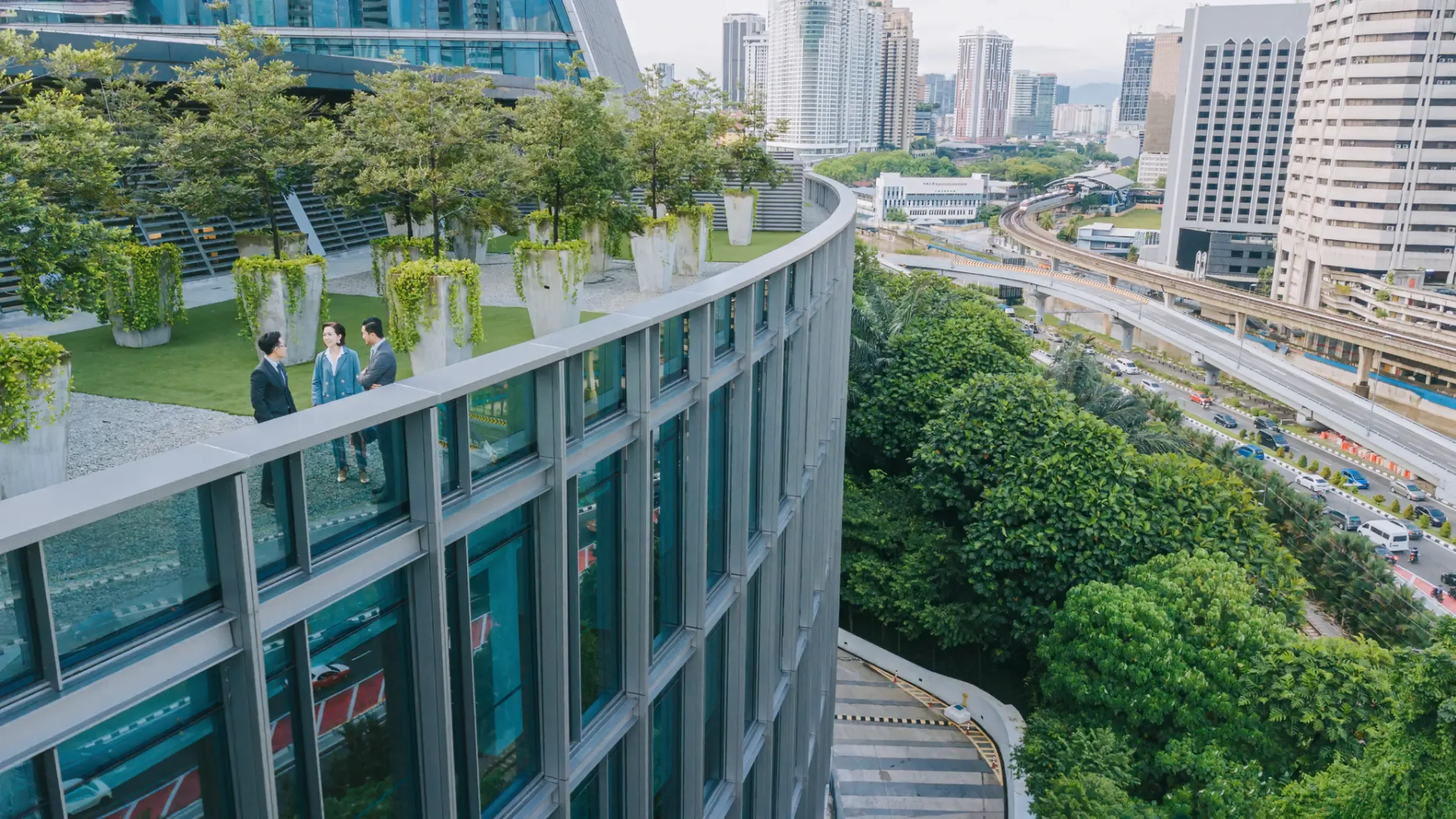 business colleagues talking in a garden outside an office building