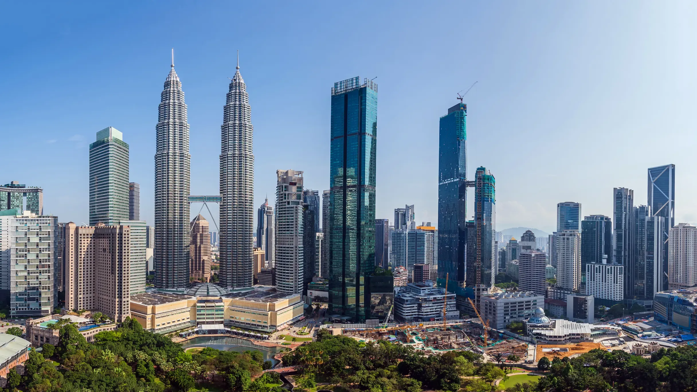 Kuala Lumpur, Malaysia, featuring a skyline of modern skyscrapers. 