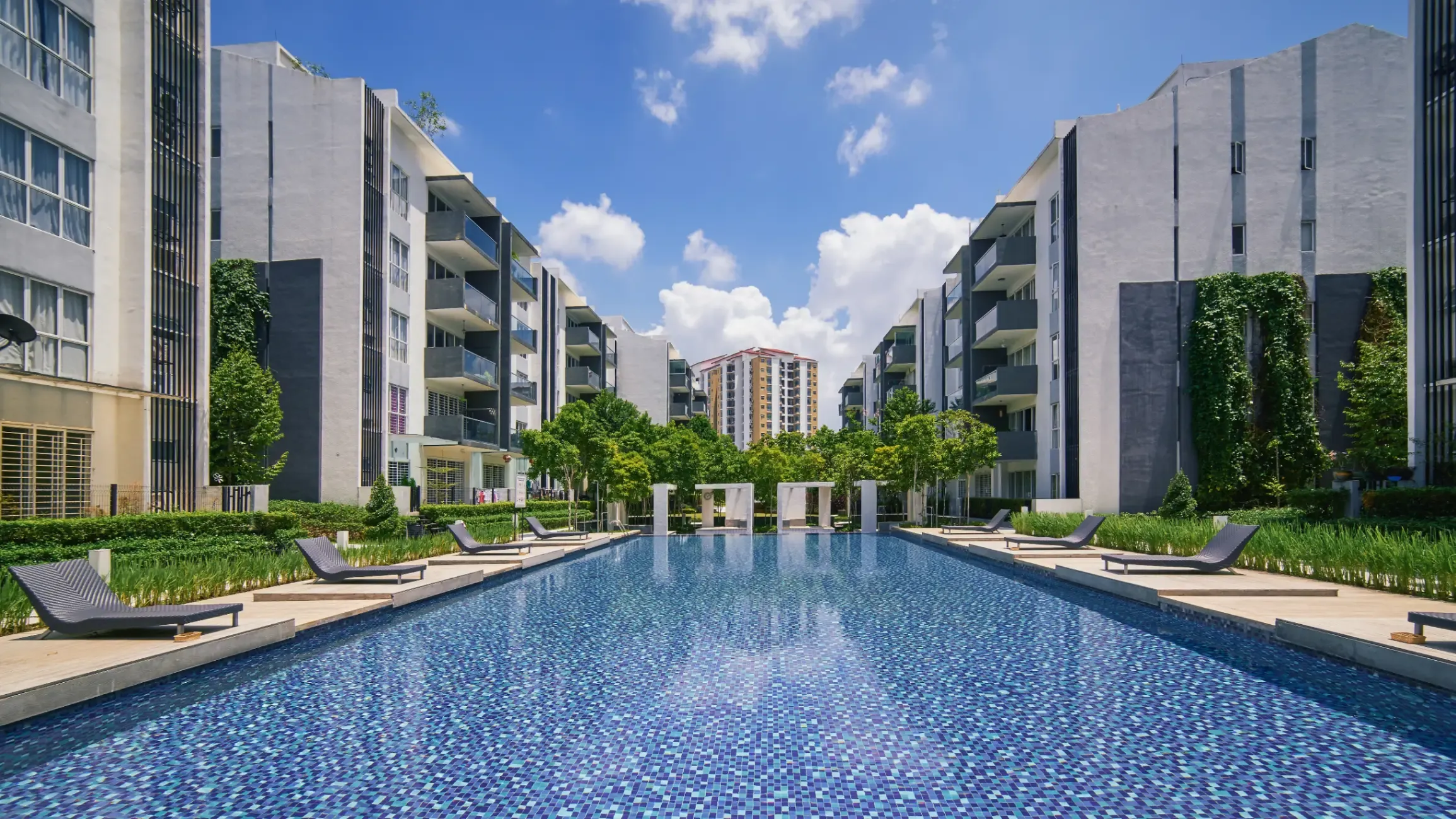 Modern residential buildings with landscaped outdoor facilities, shared amenities, and contemporary architectural design. 