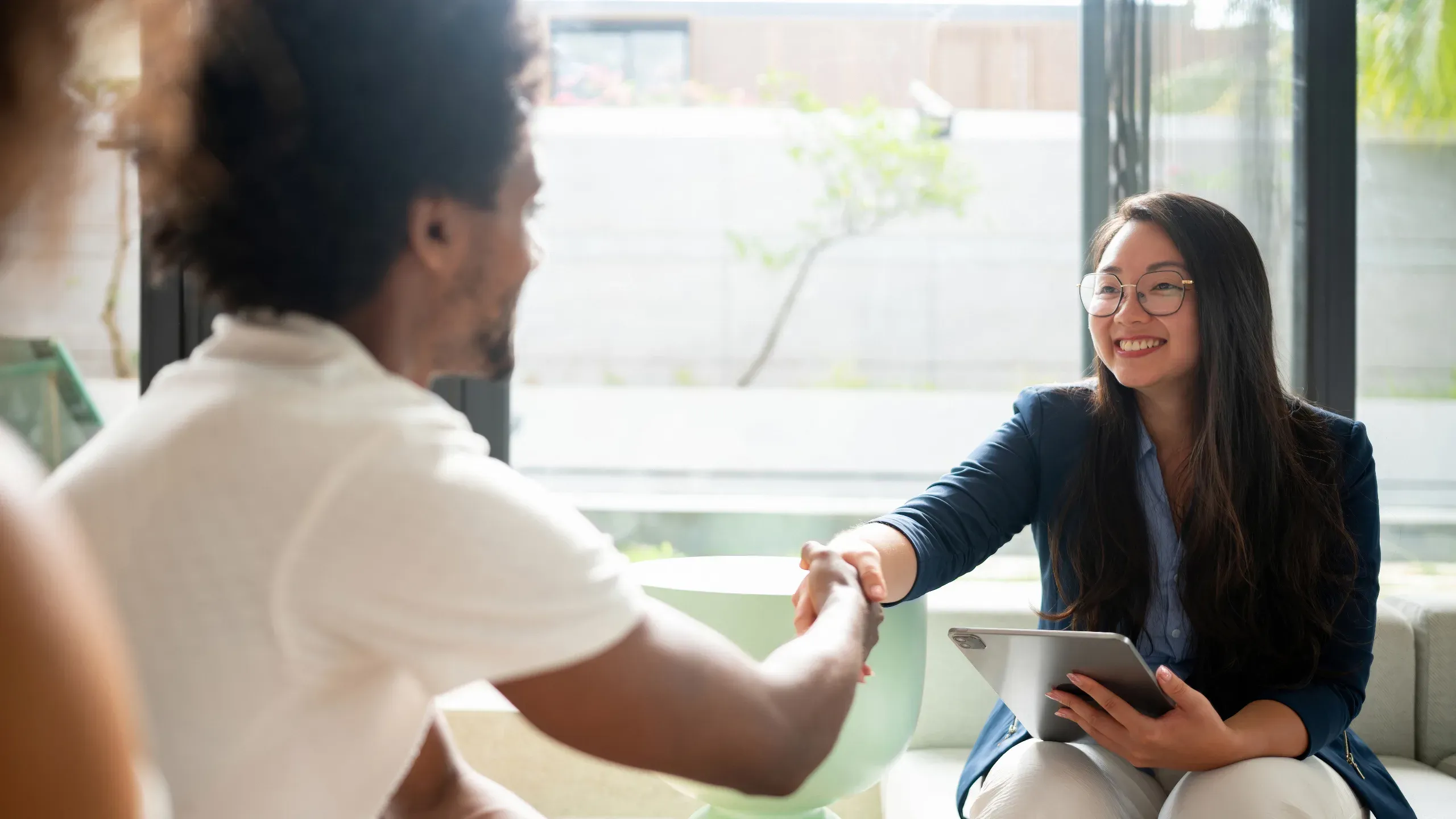 Real estate agent closing a deal with a handshake, marking a successful property agreement. 