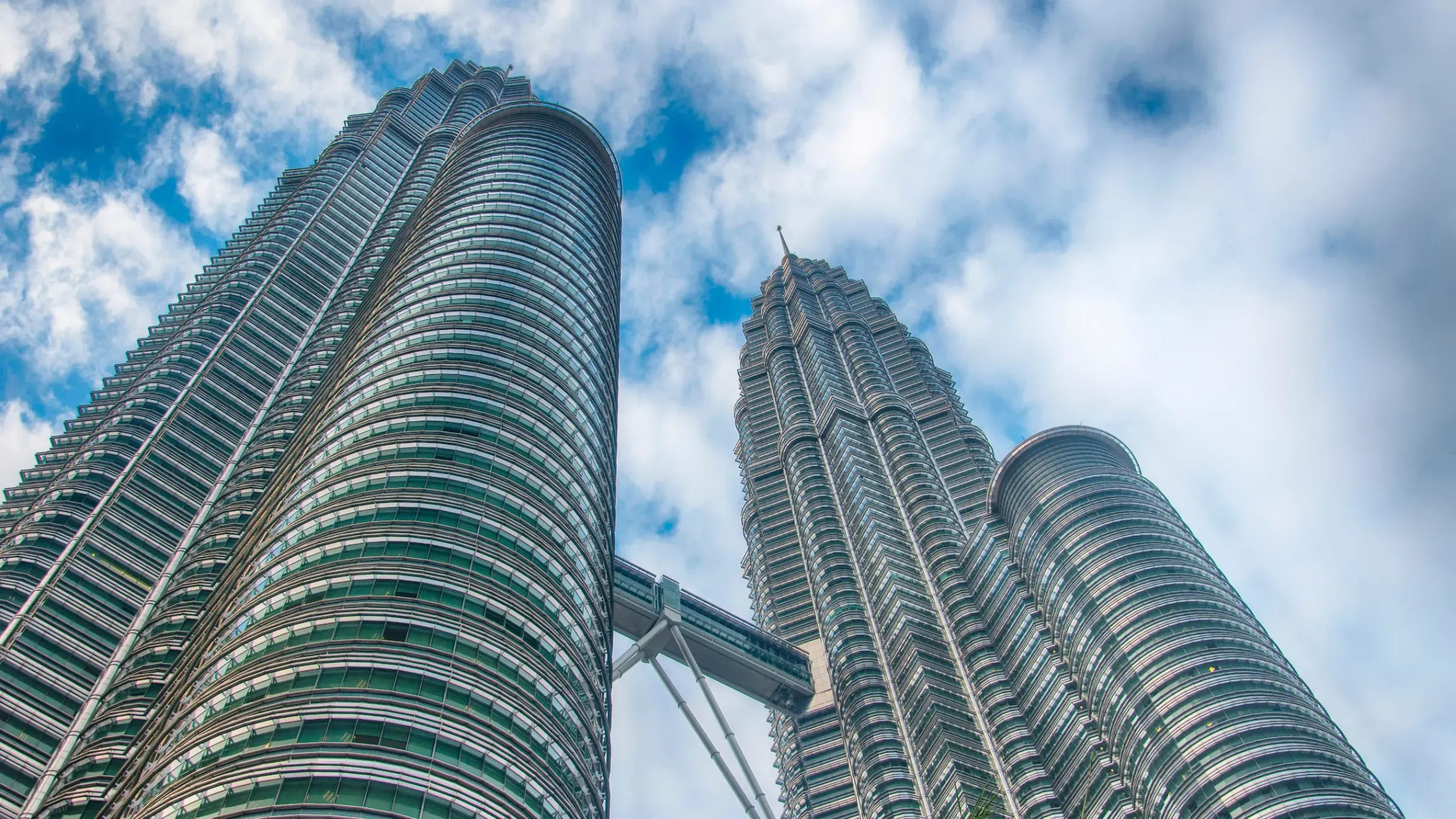 The Petronas Twin Towers rising above Kuala Lumpur’s city skyline, showcasing the city’s iconic modern architecture. 