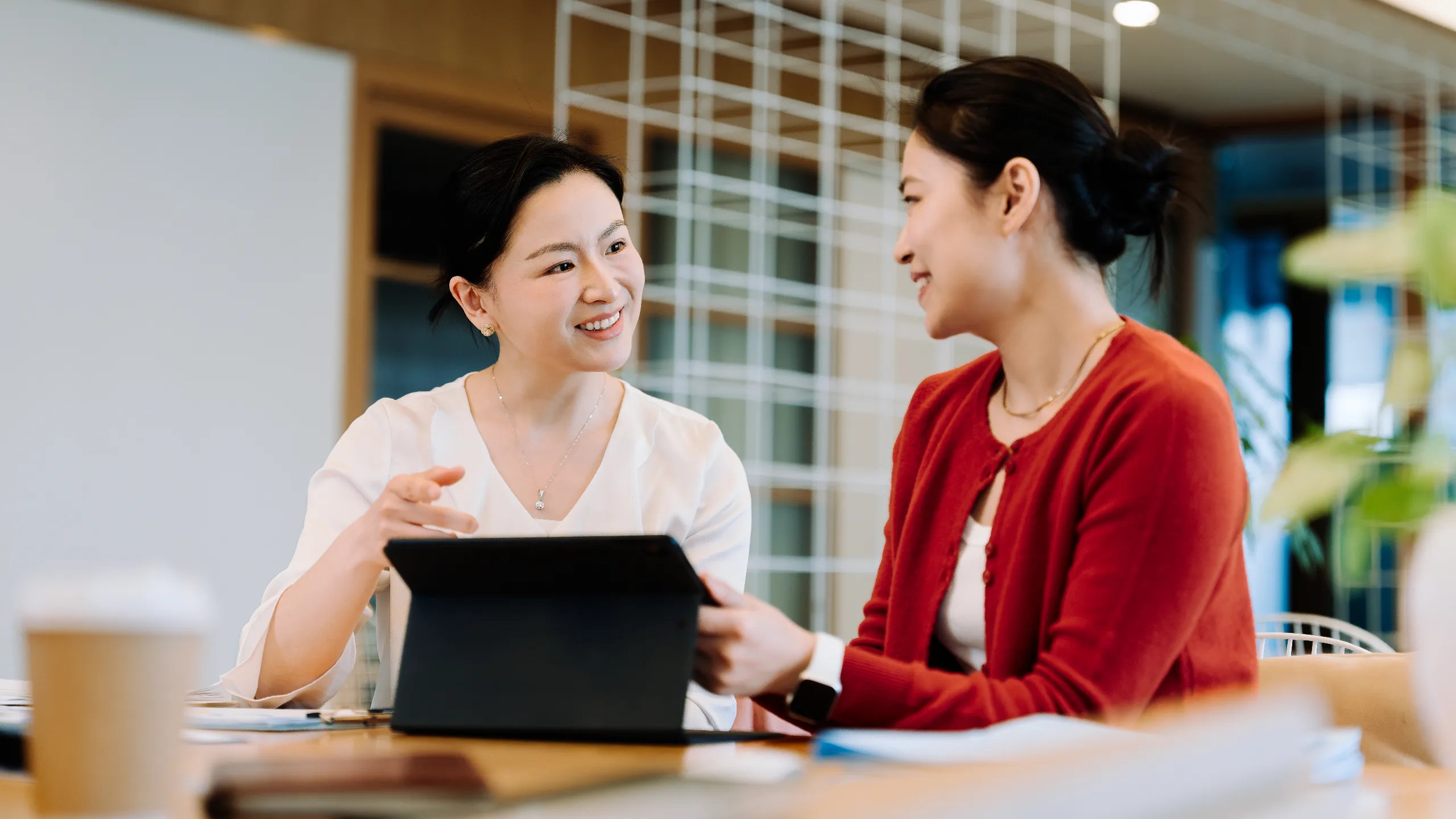 two-asian-businesswomen-working-together-on-a-computer