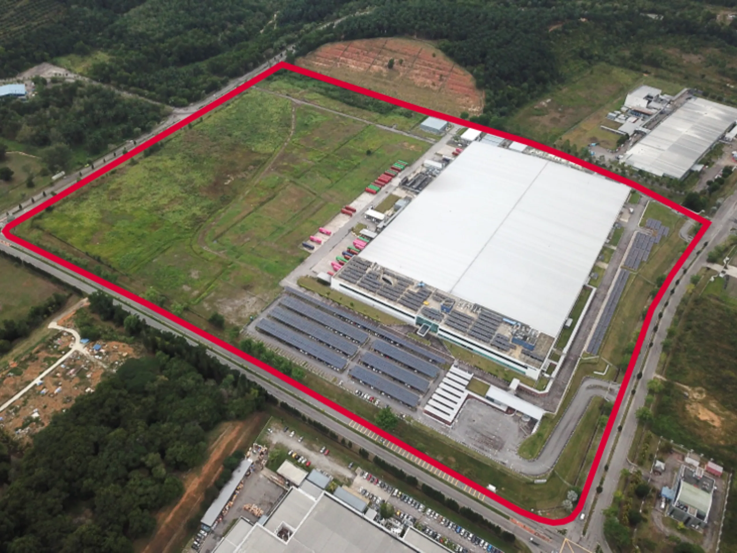 Industrial facility with a section highlighted for redevelopment, showing existing operations and the proposed development area.
