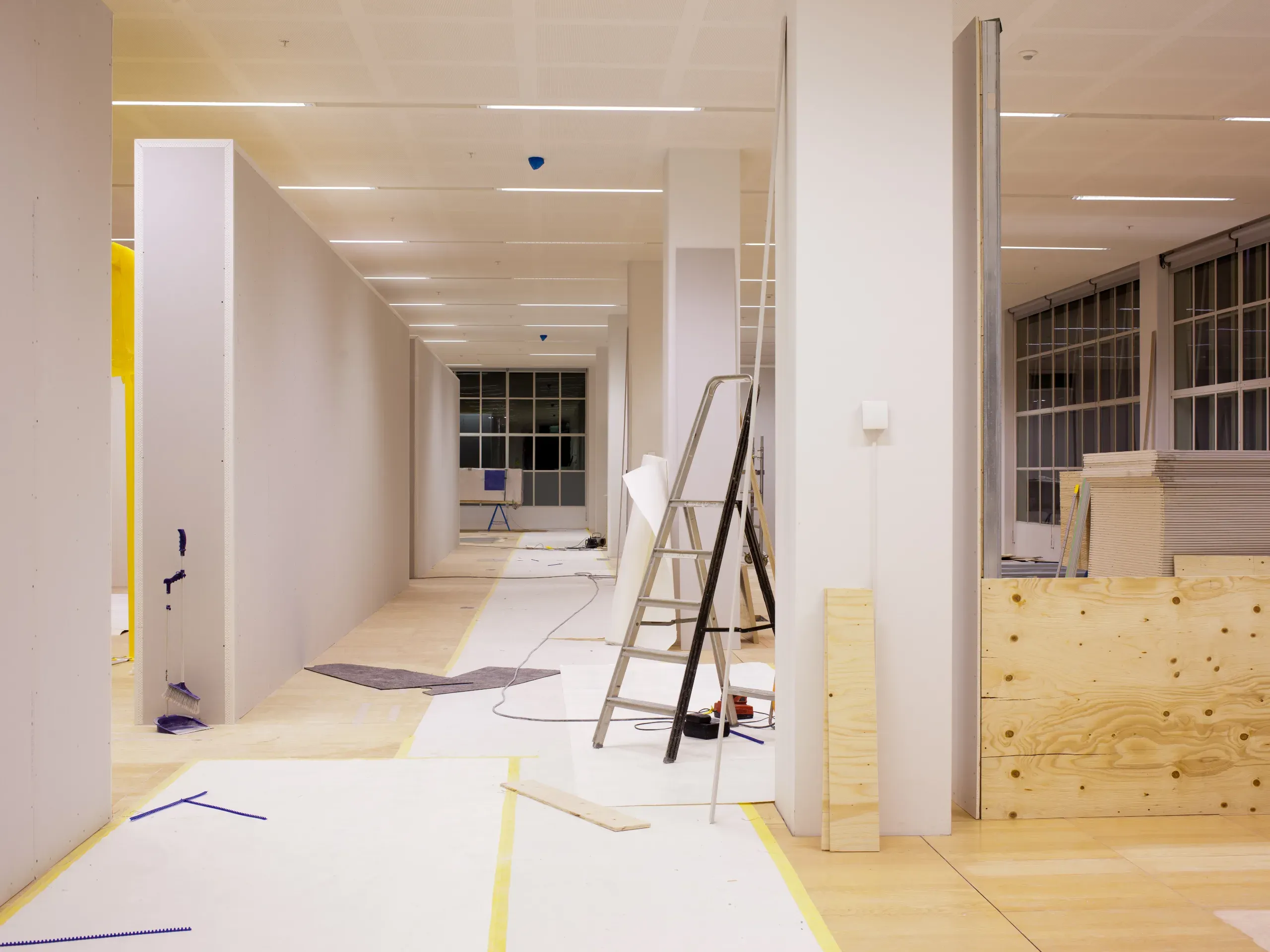 Ongoing office renovation with construction materials, updated interiors, and workspace improvements in progress. 