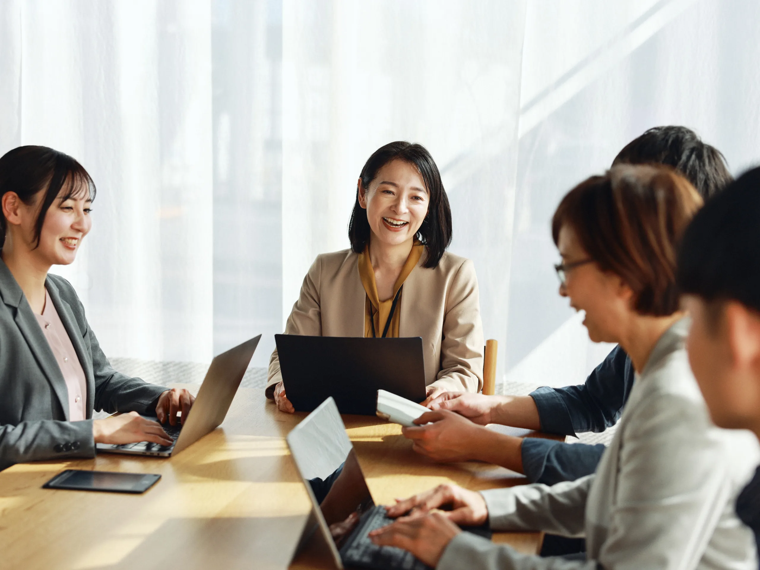Asian business executives in a meeting, discussing strategy and collaborating in a professional office setting.