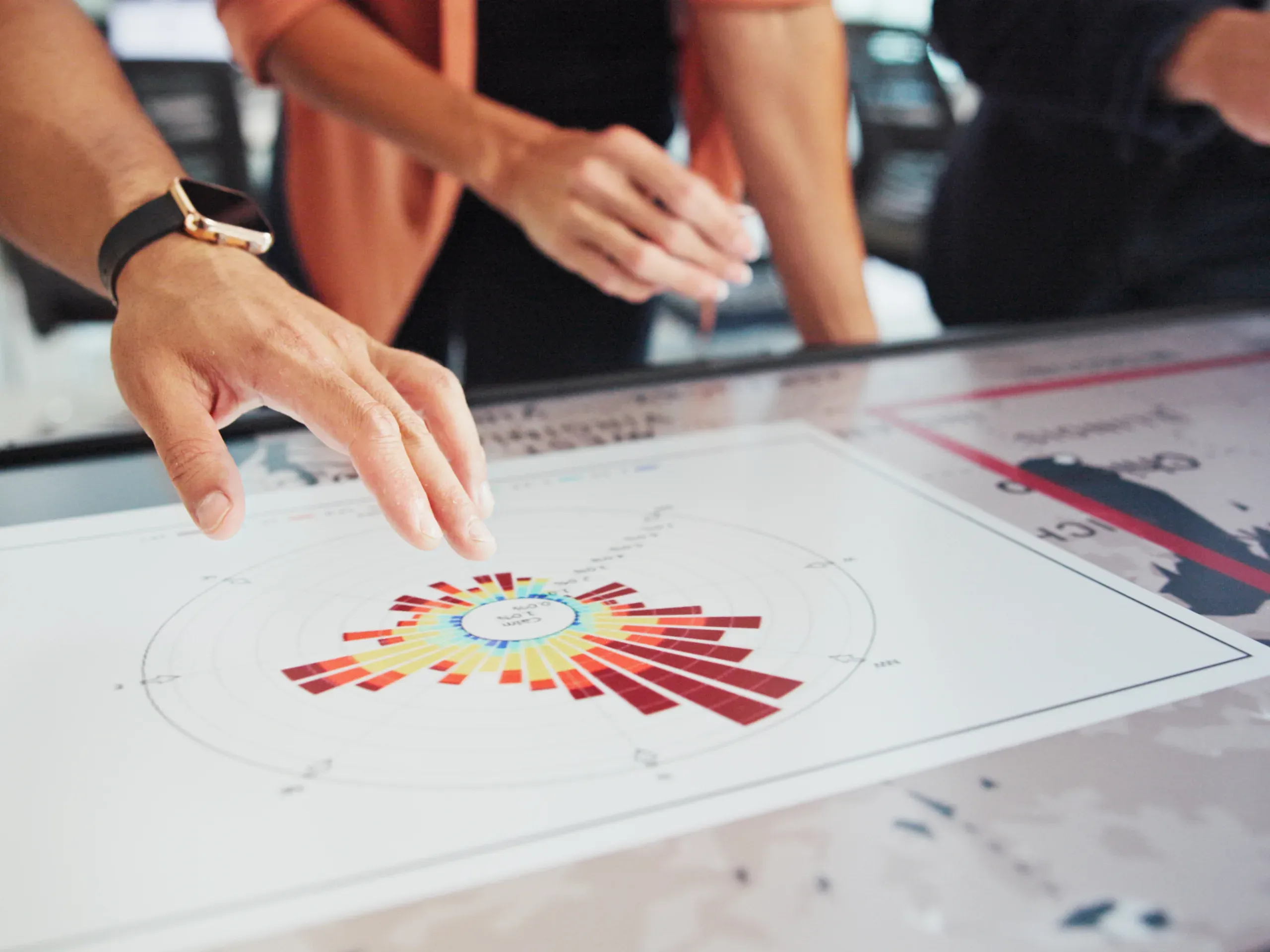 Business professionals reviewing a chart together analysing data and discussing performance insights