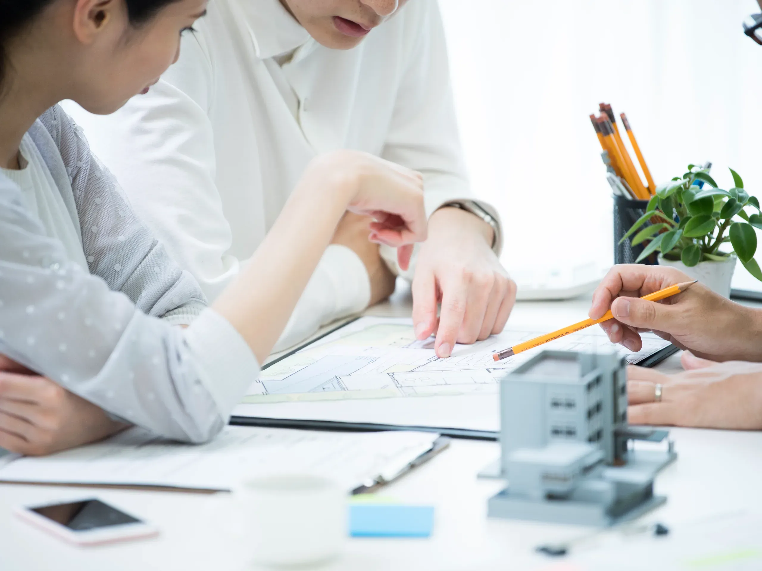 Business professionals discussing plans in a meeting, reviewing ideas and collaborating on future initiatives. 