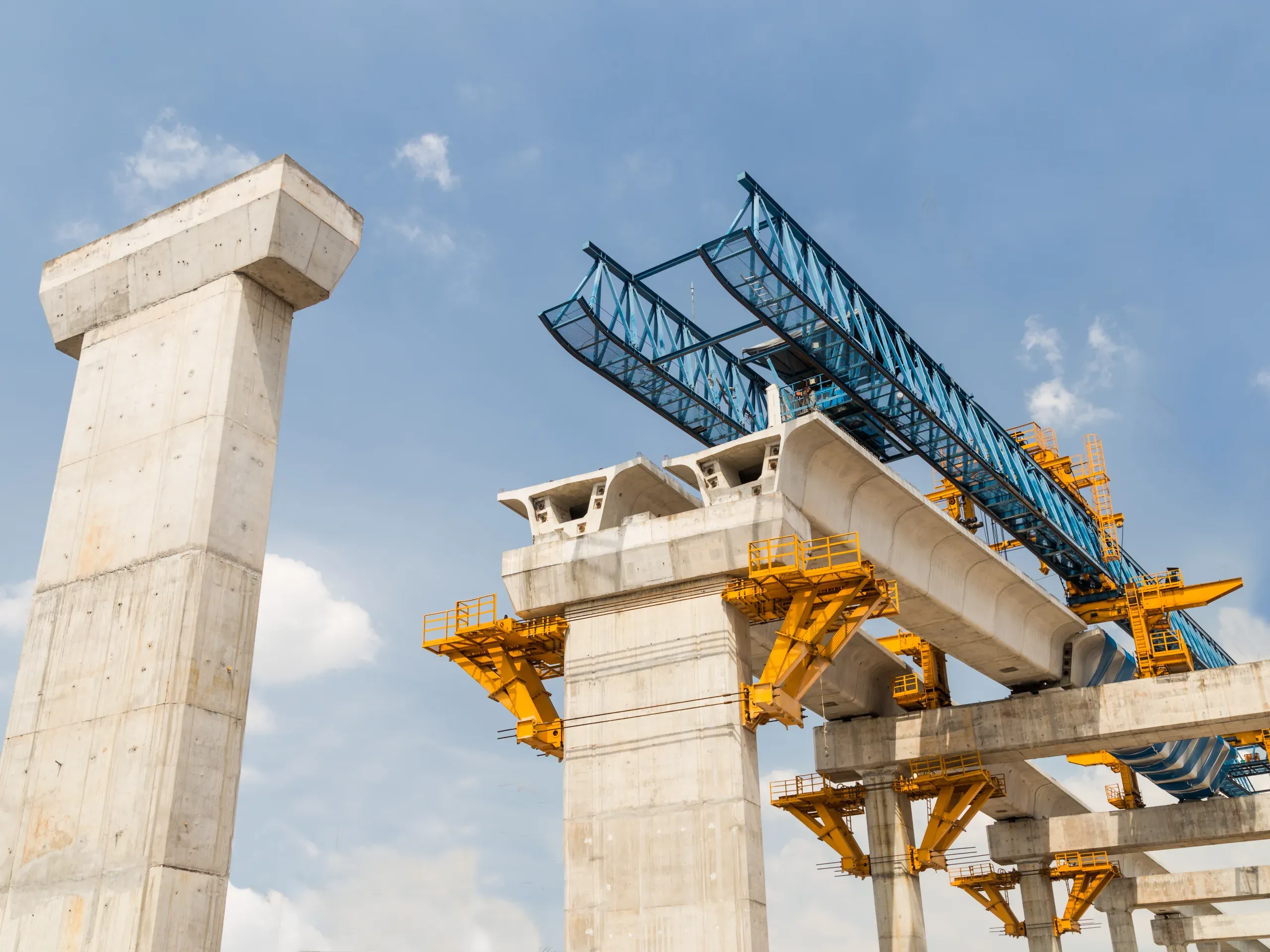Construction work underway on a mass rapid transit line, featuring infrastructure, machinery, and elevated structures. 