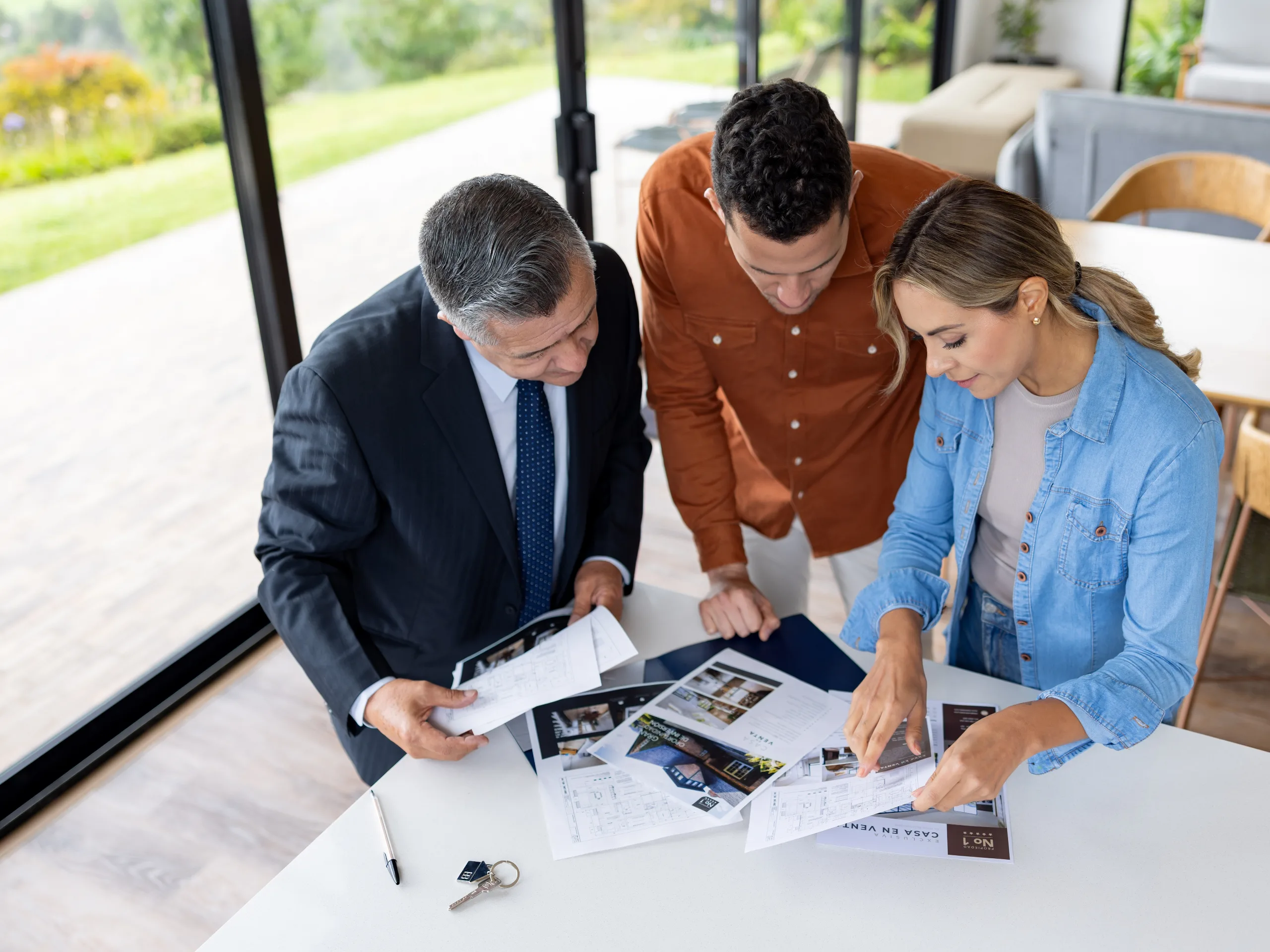 Couple reviewing house blueprints together, planning details of a residential property.