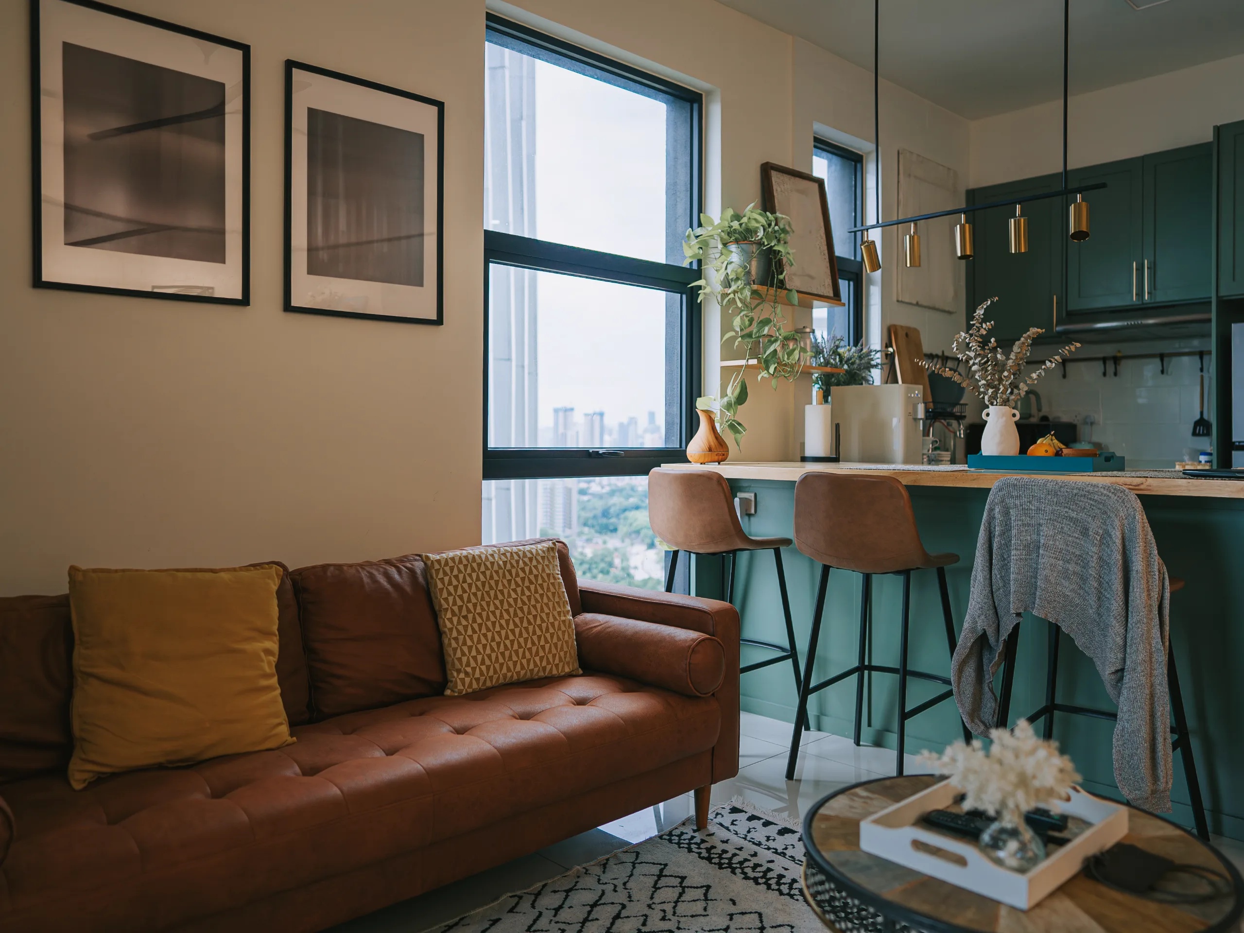 Studio apartment featuring a sofa, kitchen island, and a modern open-plan living space.