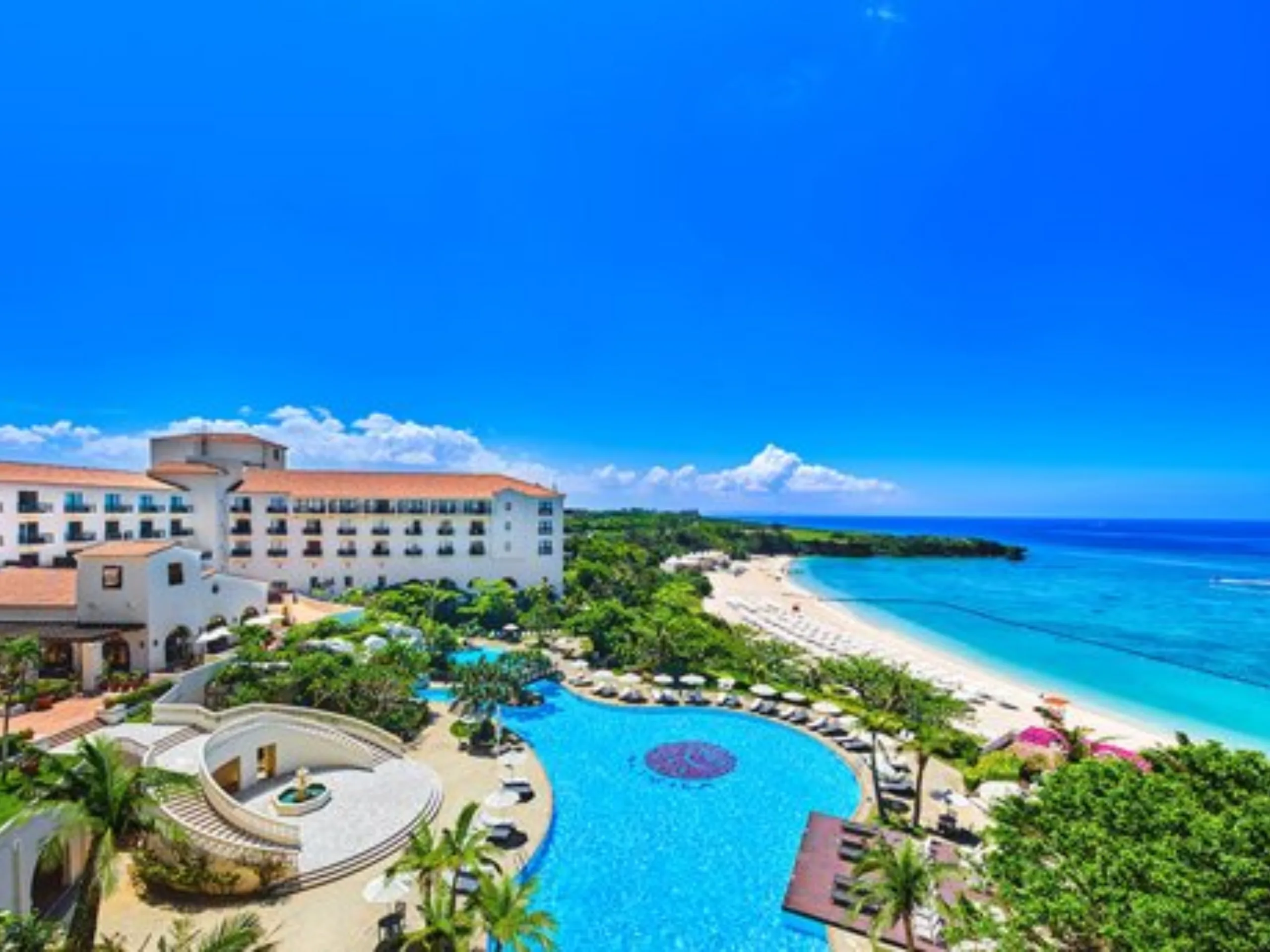 Exotic tropical resort surrounded by lush greenery, featuring luxury accommodations and a relaxing holiday setting.