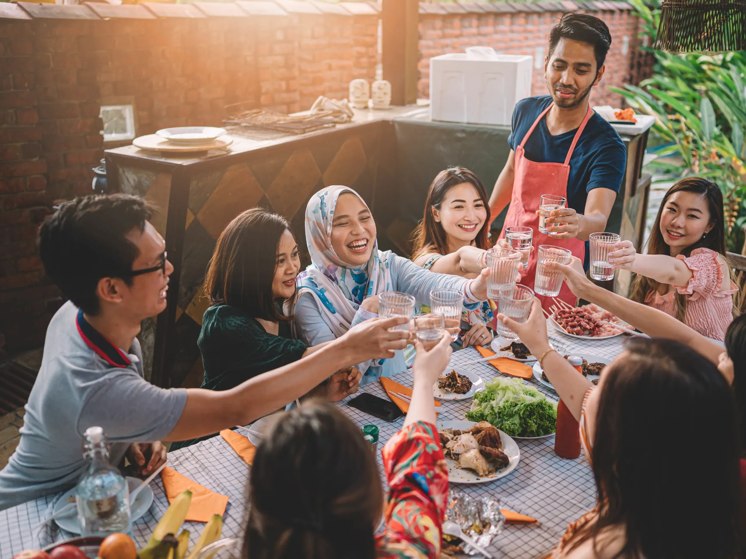 Friends enjoying a dinner party together, sharing a meal in a relaxed and social setting. 