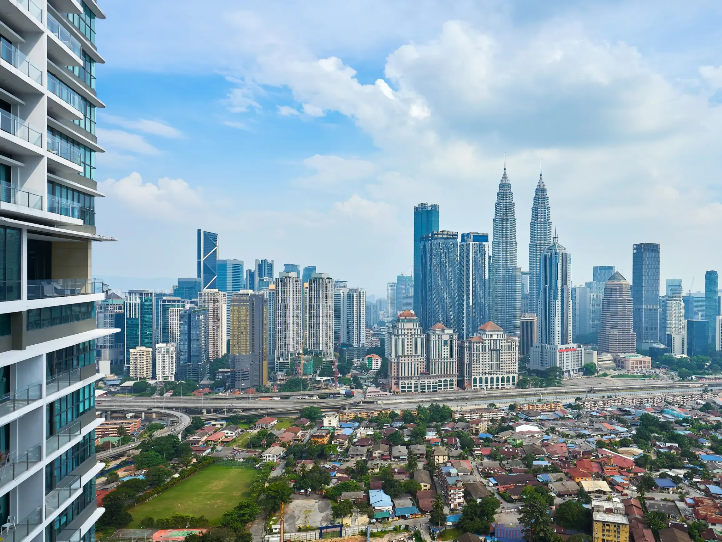 Kuala Lumpur cityscape featuring modern skyscrapers, commercial districts, and a vibrant urban environment