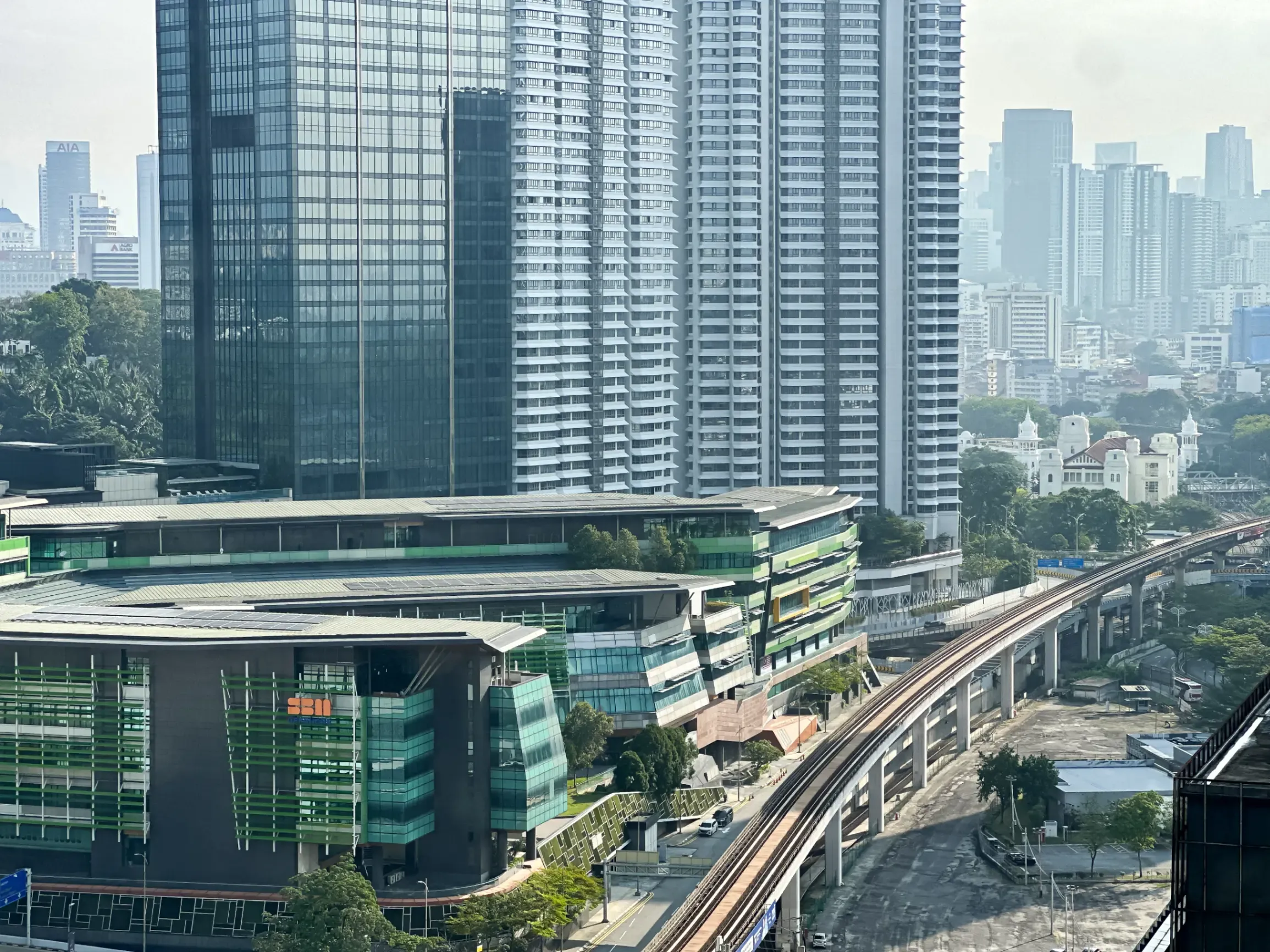 Kuala Lumpur urban skyline with rail tracks in the foreground, highlighting the city's modern infrastructure and high-rise buildings
