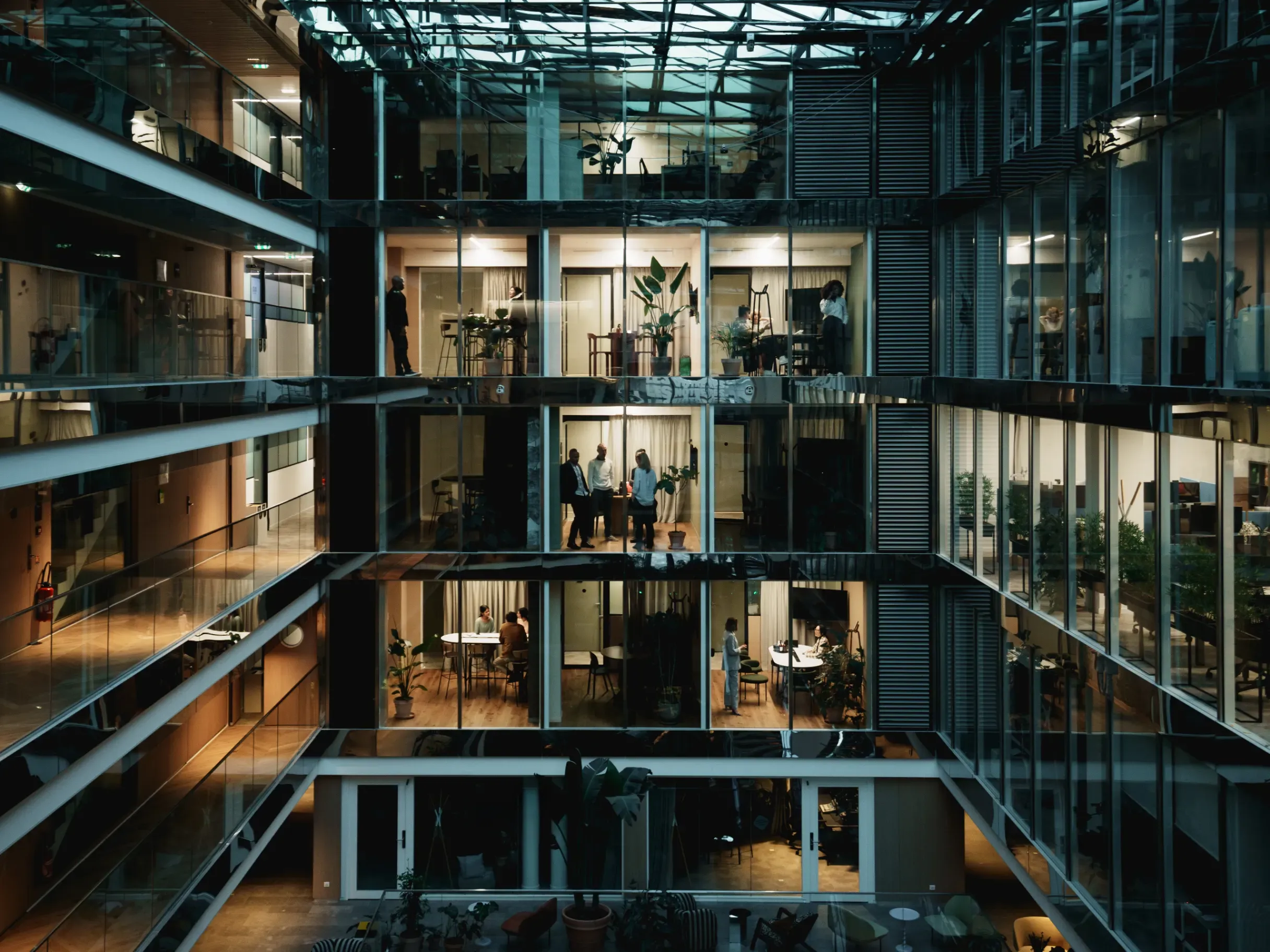 Modern office building illuminated at night, featuring contemporary architecture and a striking urban presence