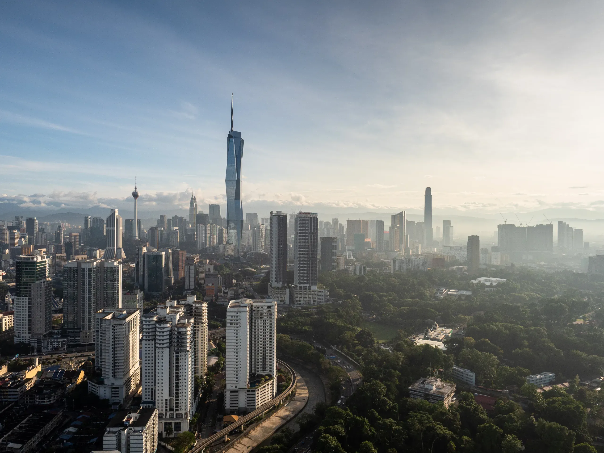 Morning view of Kuala Lumpur’s city skyline, featuring modern skyscrapers illuminated by early daylight