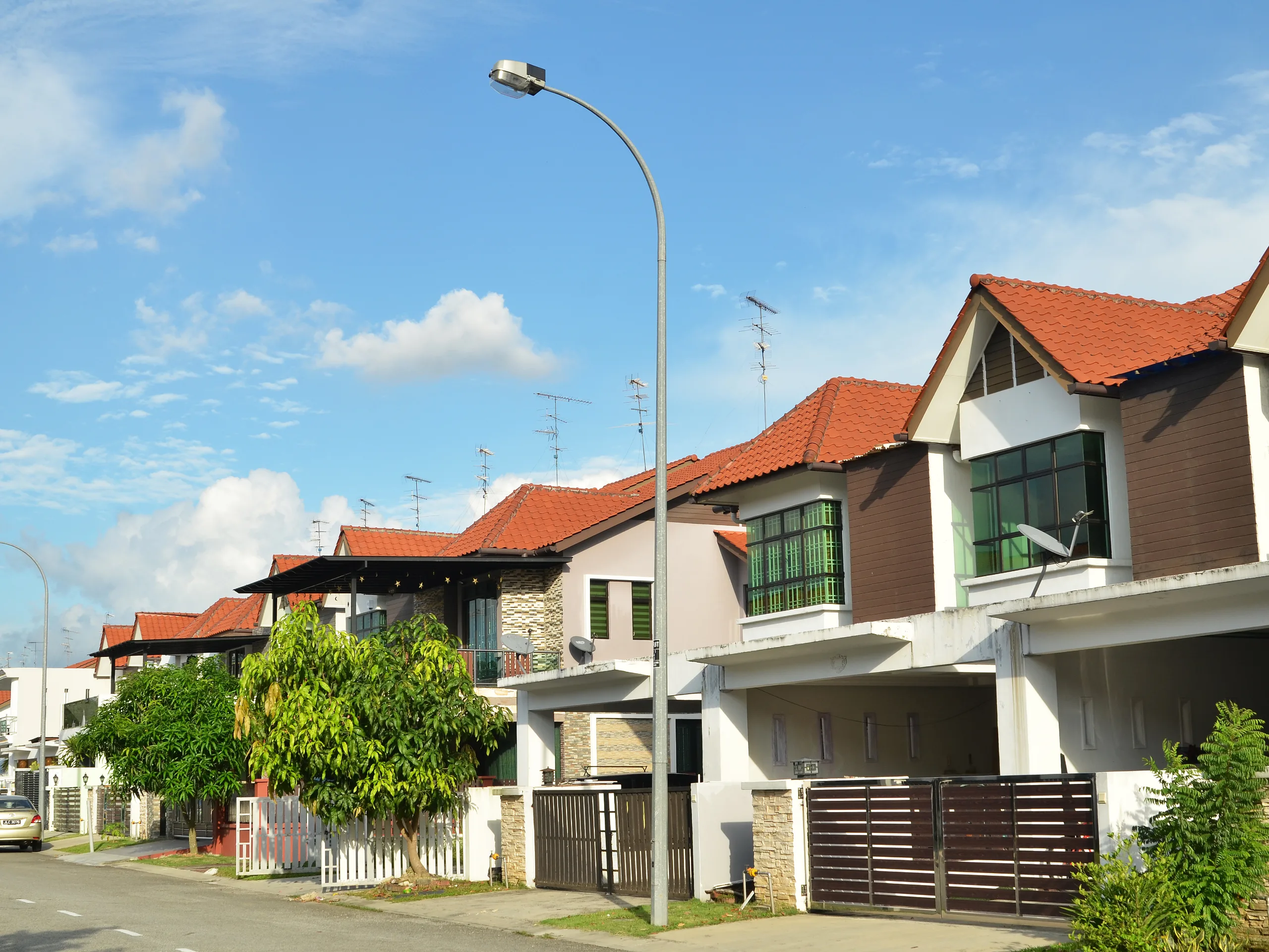 Row of newly built terrace houses featuring modern residential design and landscaped surroundings.