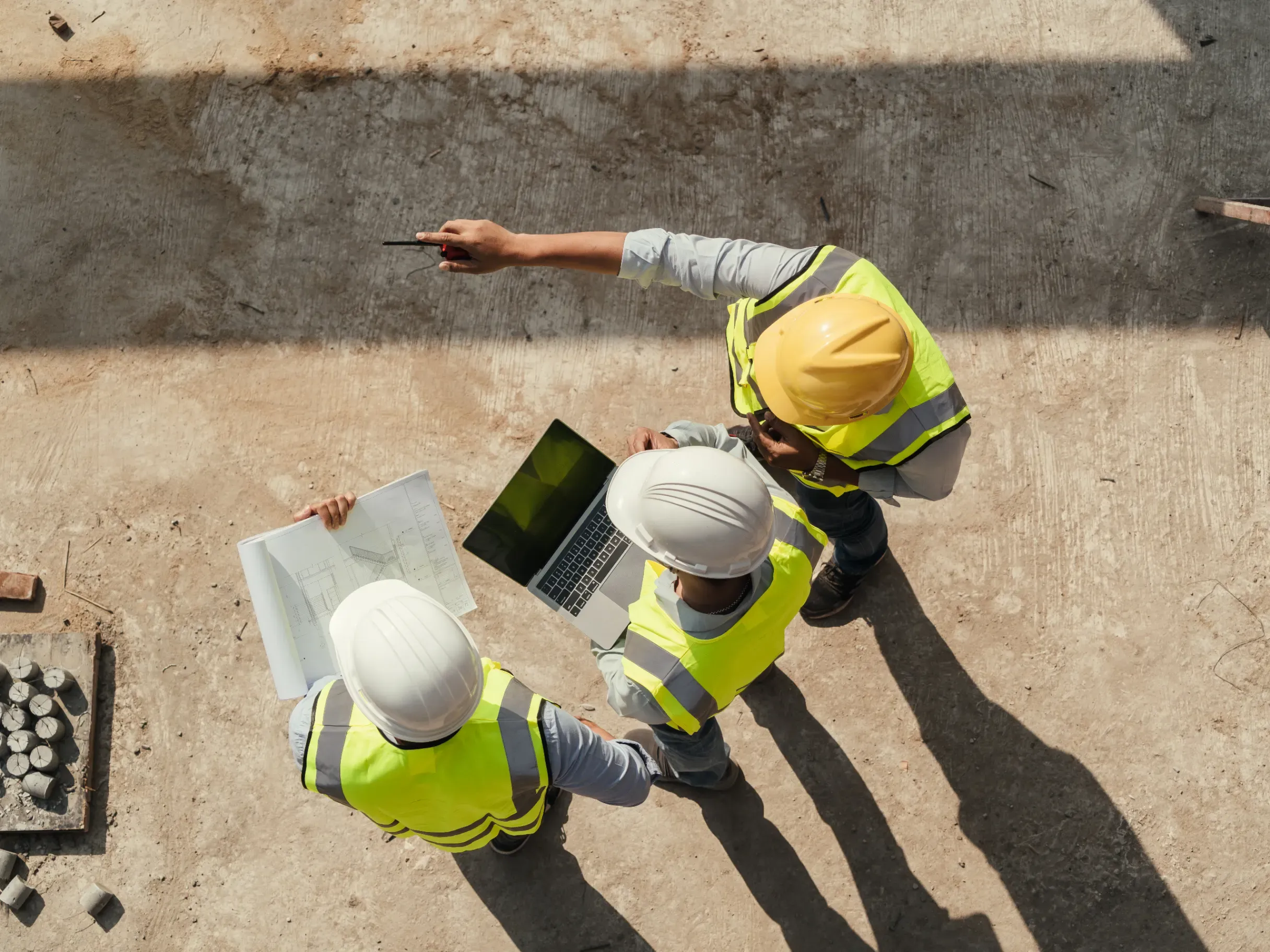 Overhead view of a building inspection at a construction site, showing personnel assessing progress and site conditions. 