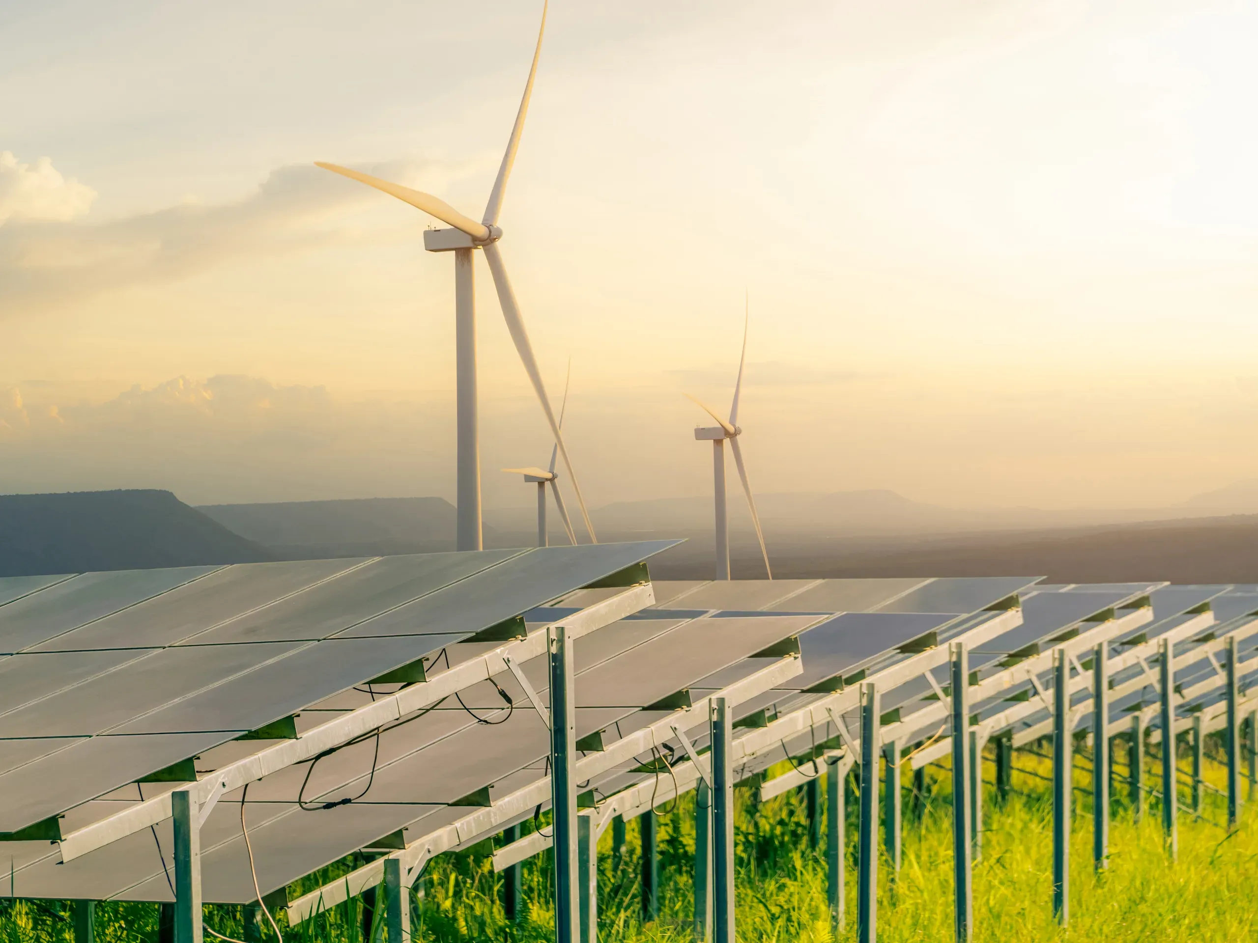 Solar panels and wind turbines generating renewable energy across a large sustainable energy site