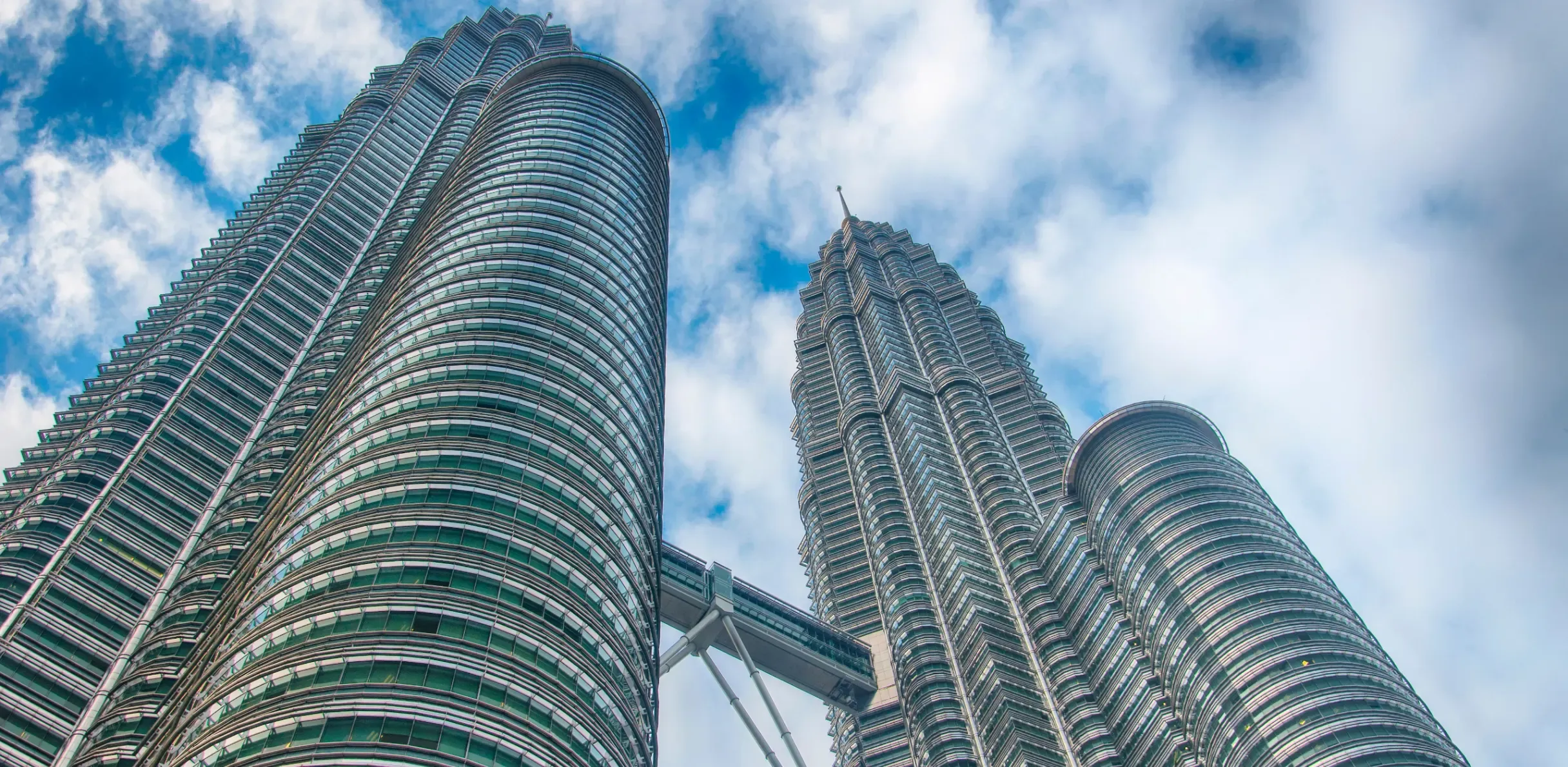 The Petronas Twin Towers rising above Kuala Lumpur’s city skyline, showcasing the city’s iconic modern architecture. 