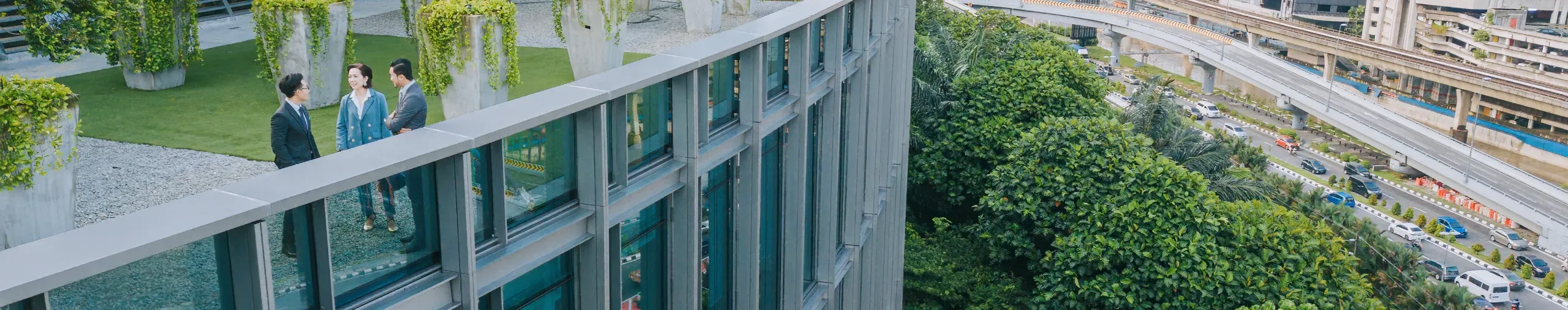 business colleagues talking in a garden outside an office building