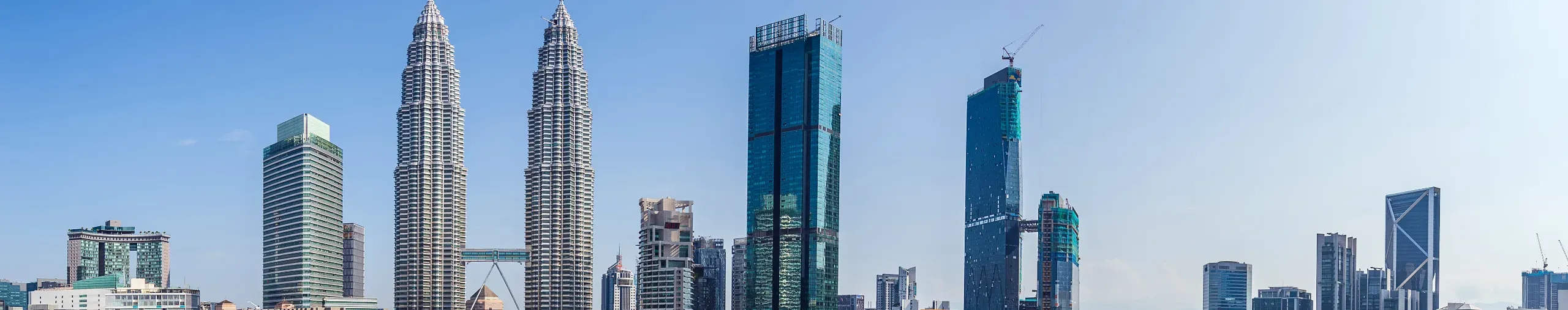 Kuala Lumpur, Malaysia, featuring a skyline of modern skyscrapers.